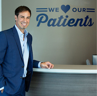 Smiling man in suit at clinic reception